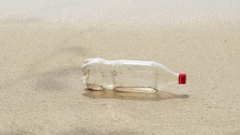 Beverage-plastic-container-thrown-at-sandy-beach
